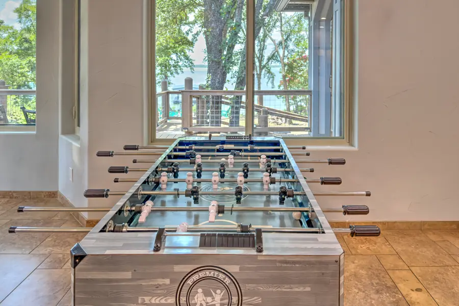 Foosball table in front of a window looking out to the lake
