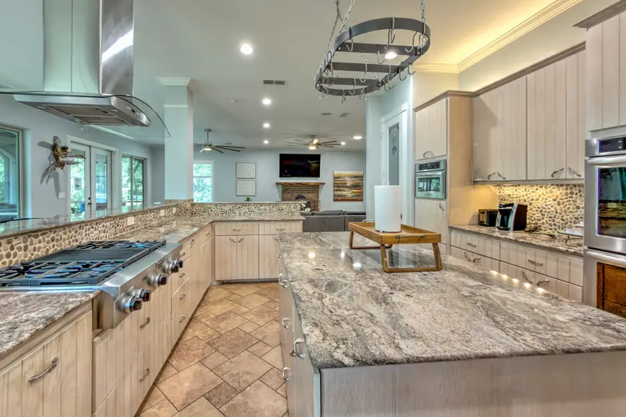Kitchen with a granite island, gas range and double wall ovens