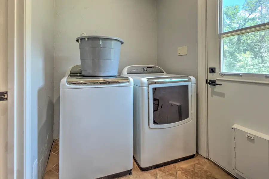 Laundry room with a top-loading washer and a dryer