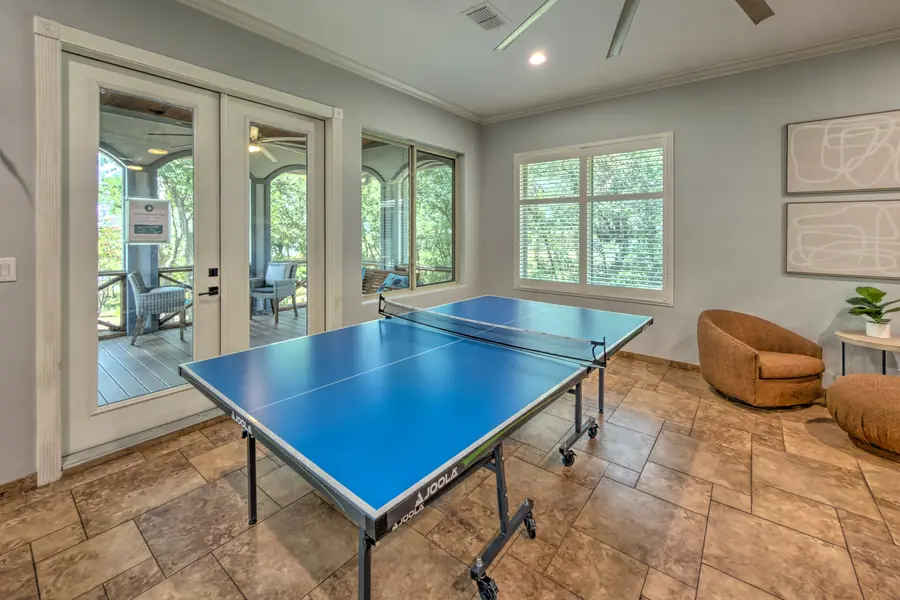 Ping-pong table beside French doors to the screened porch